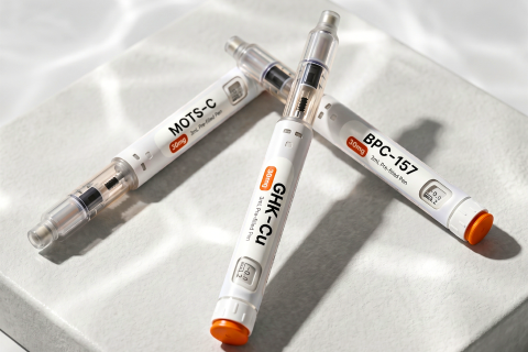 Peptide auto-injector pens, GHK-Cu, MOTS-C, TB-500 and BPC-157, on travertine and marble